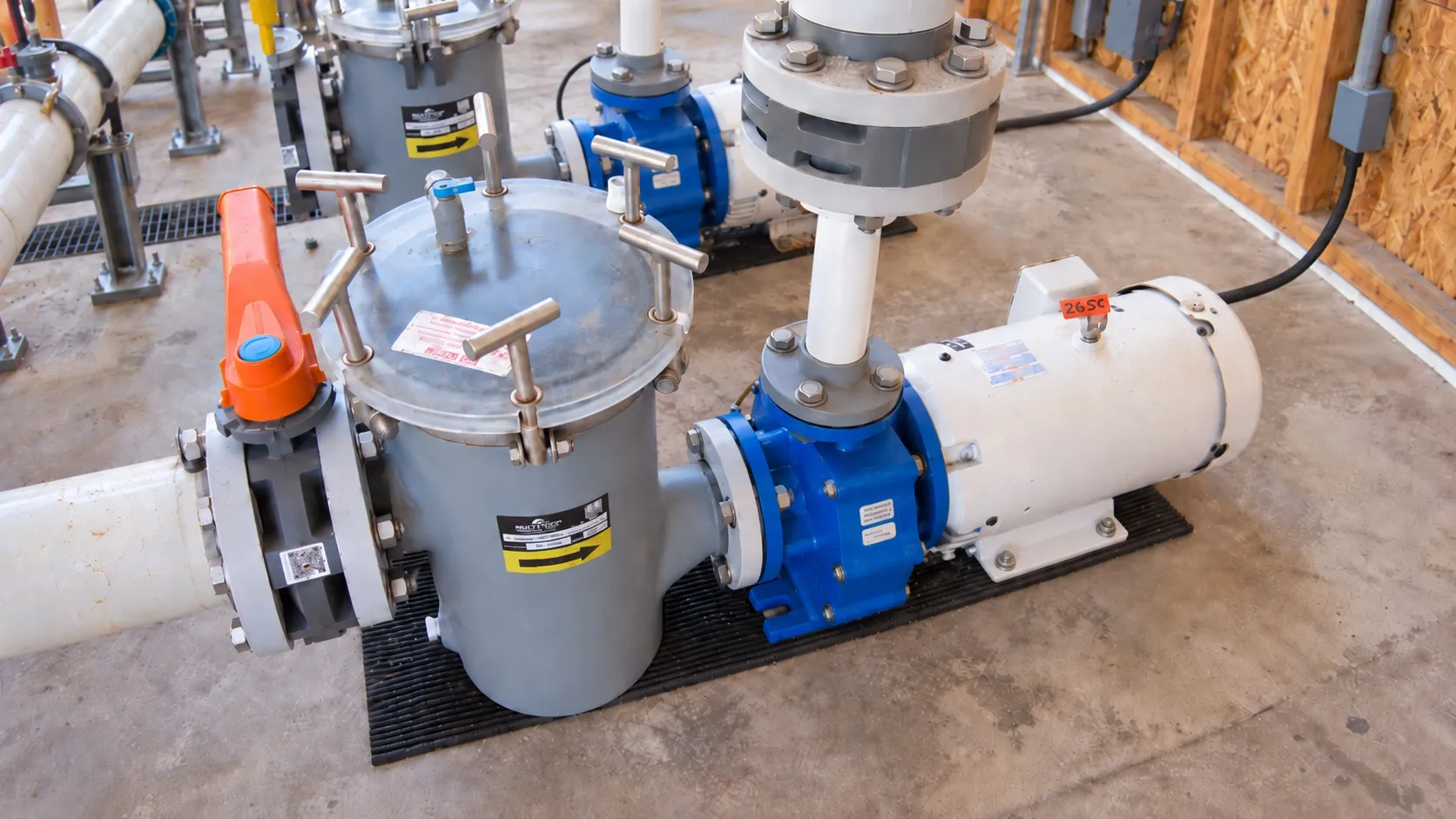 Clear-body basket strainers with perforated stainless baskets on a flanged header